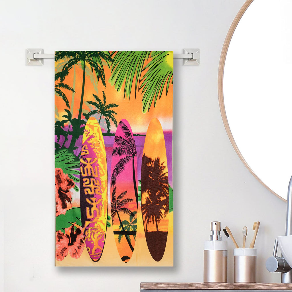 Yellow Bee beach-themed towel with surfboards and palm trees, displayed on wall.