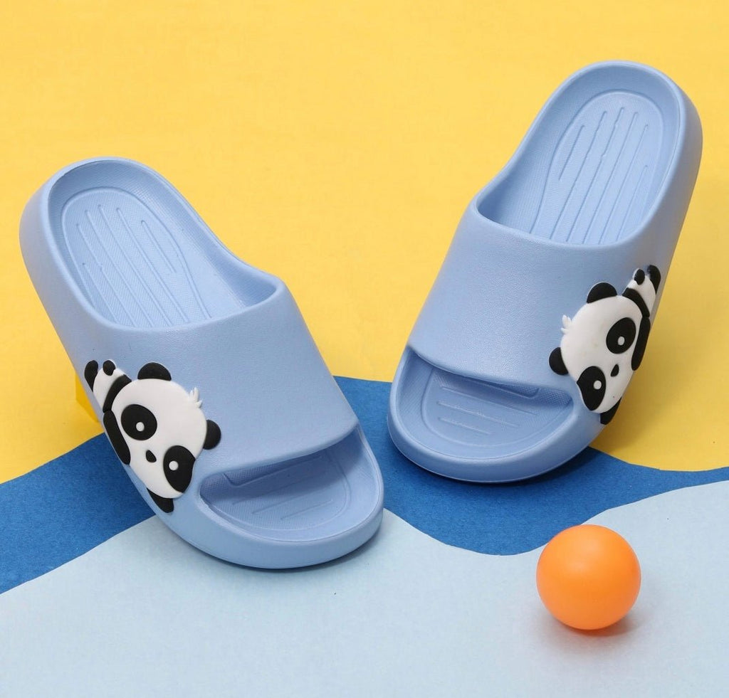 blue panda embossed slide sandals on a yellow background with an orange ball.