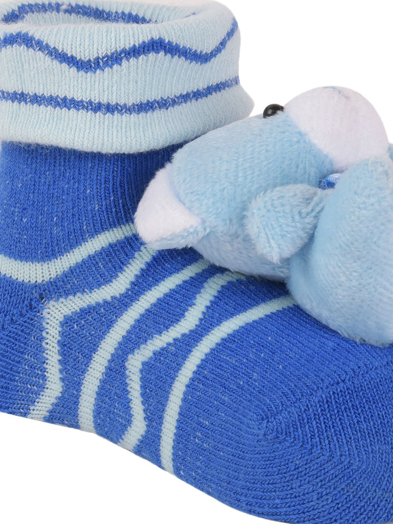 Blue teddy bear socks with plush toy detail, designed for infant comfort and fun