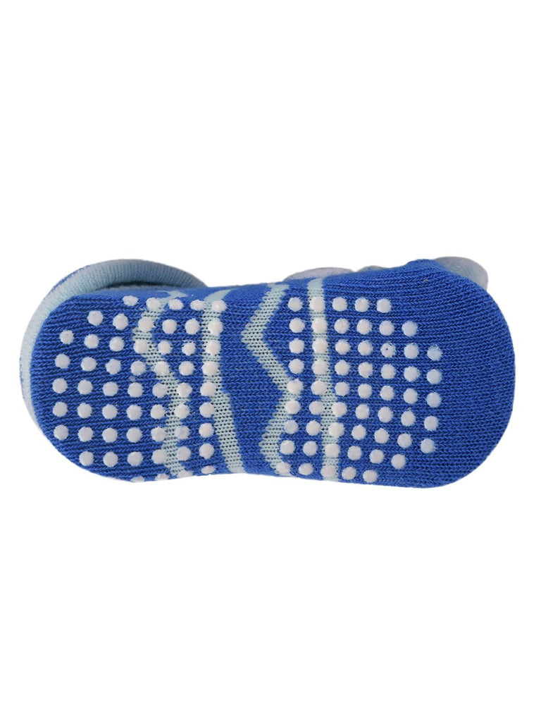 Sole view of blue teddy bear socks showing anti-slip design and striped details