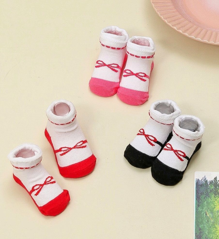 Pair of white and pink bow-printed socks for infant girls.