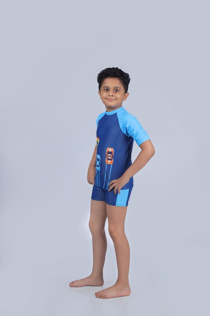 Child posing in Yellow Bee's Blue Car Print Swimsuit, showcasing the colorful design.
