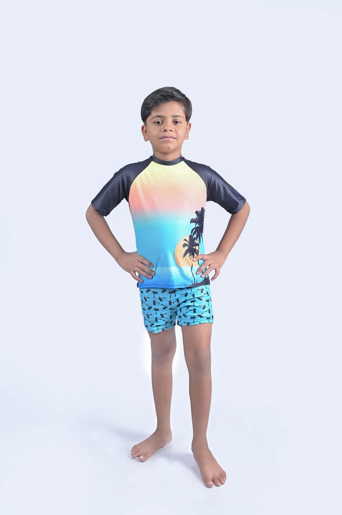 Boy Showcasing Front of Yellow Bee's Sunset Palm Tree Printed Swimwear
