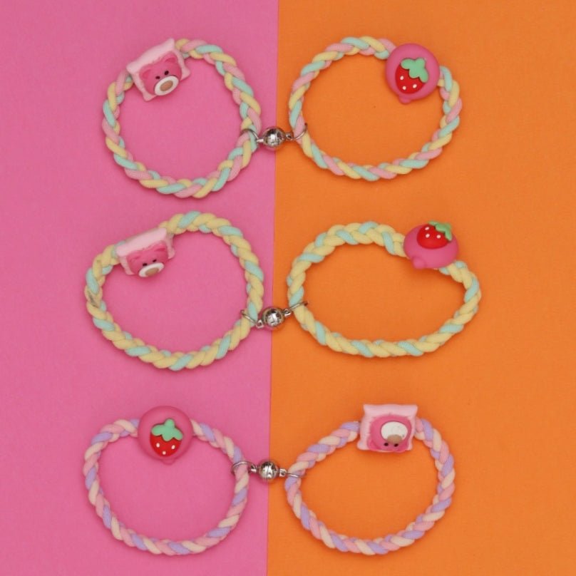 Set of Yellow Bee multi-colored braided rubber bands featuring bear and strawberry charms with a magnet feature