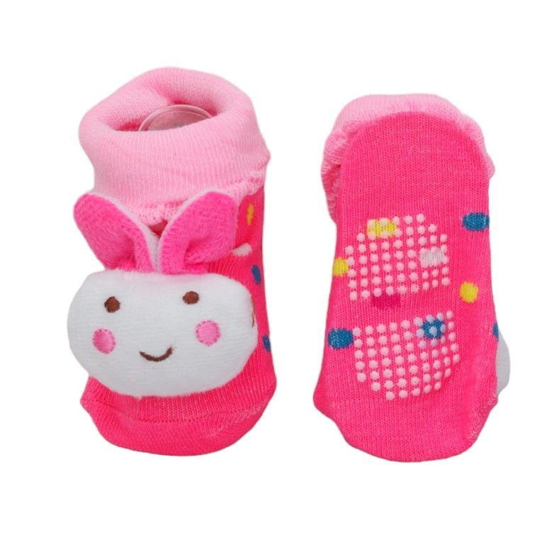 Baby girl socks with pink rabbit design and non-slip dots on the sole.