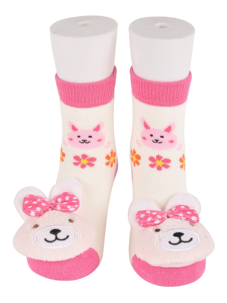 Infants' bunny stuffed toy socks in white and pink with a playful bow.
