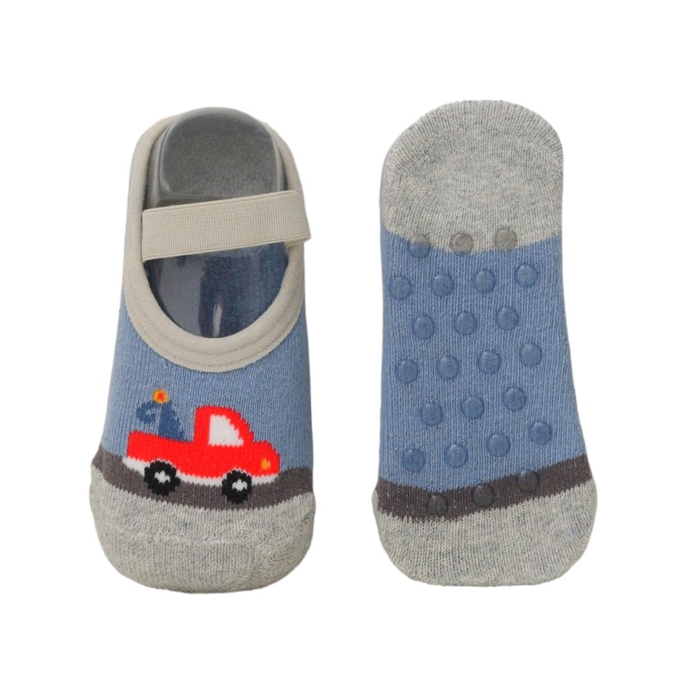 Infant socks with a red car design and anti-slip soles, displayed with toys.
