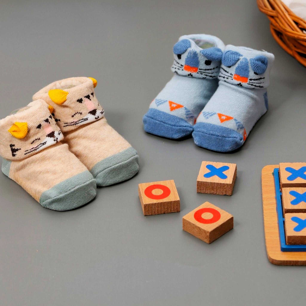 Tan and aqua baby socks with whimsical cat face and anti-slip feature by Yellow Bee.