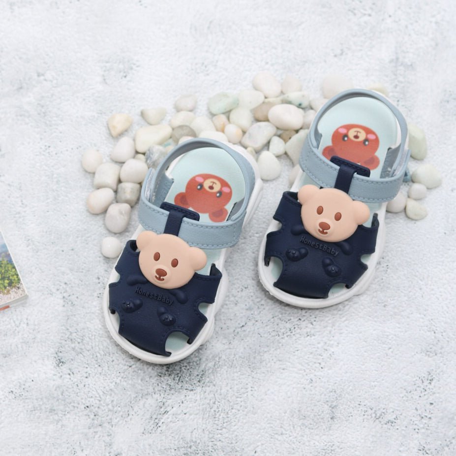 Pair of Bear Applique Sandals for toddlers displayed on a textured background