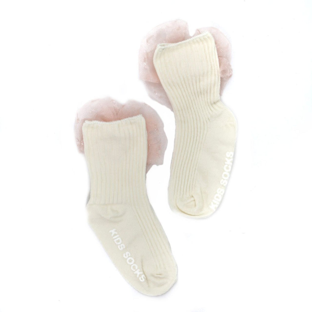 Two peach kids' socks with bow details lying flat against a white background
