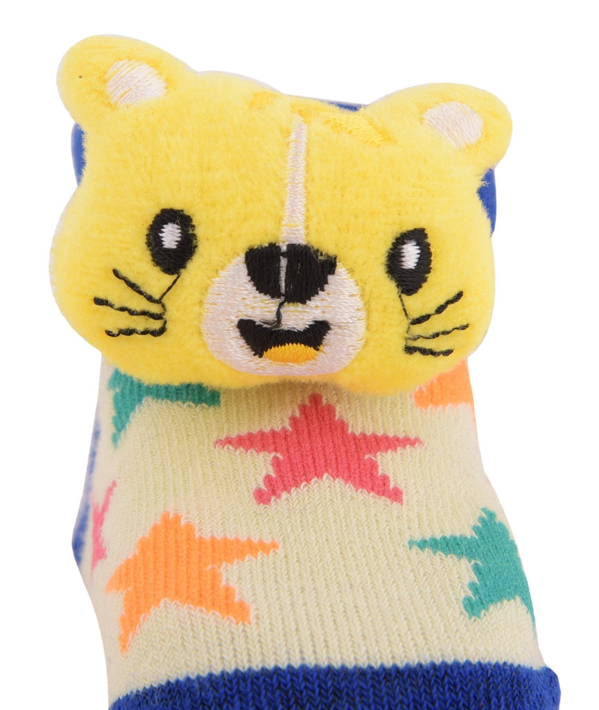 Close-up of vibrant yellow bear face on plush toy socks for Infants