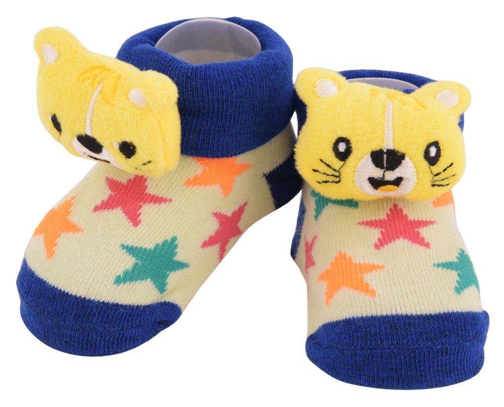 Adorable pair of yellow bear plush toy socks for toddlers on a white background.