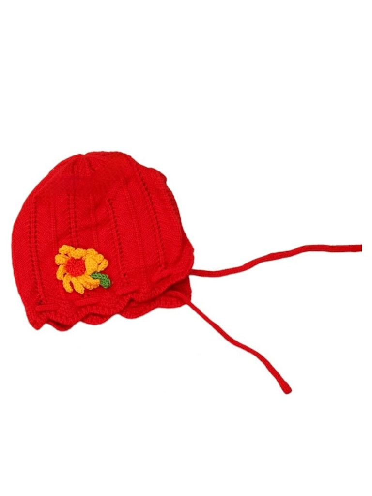 Close-up of girl's red knitted wool beanie with flower applique for 1-2 years.