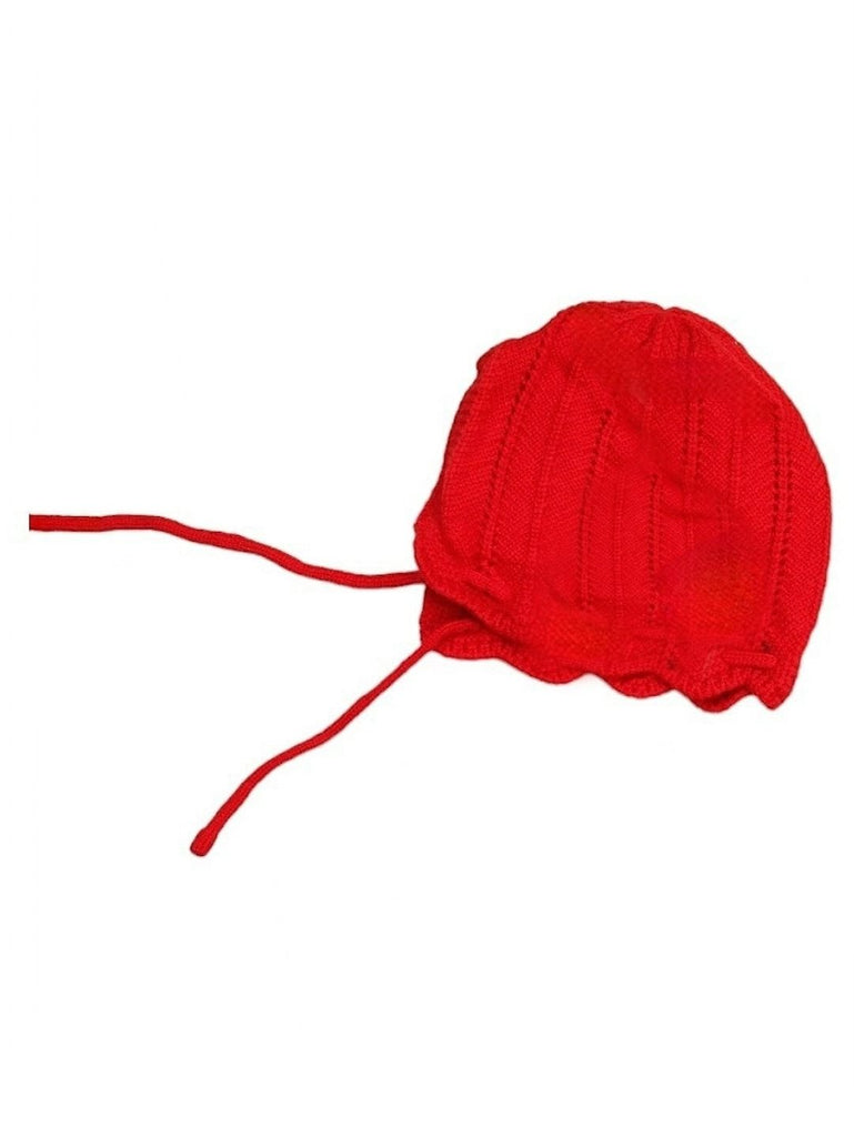 Girl's red wool muffler, part of a winter beanie set, laid out on a white surface.