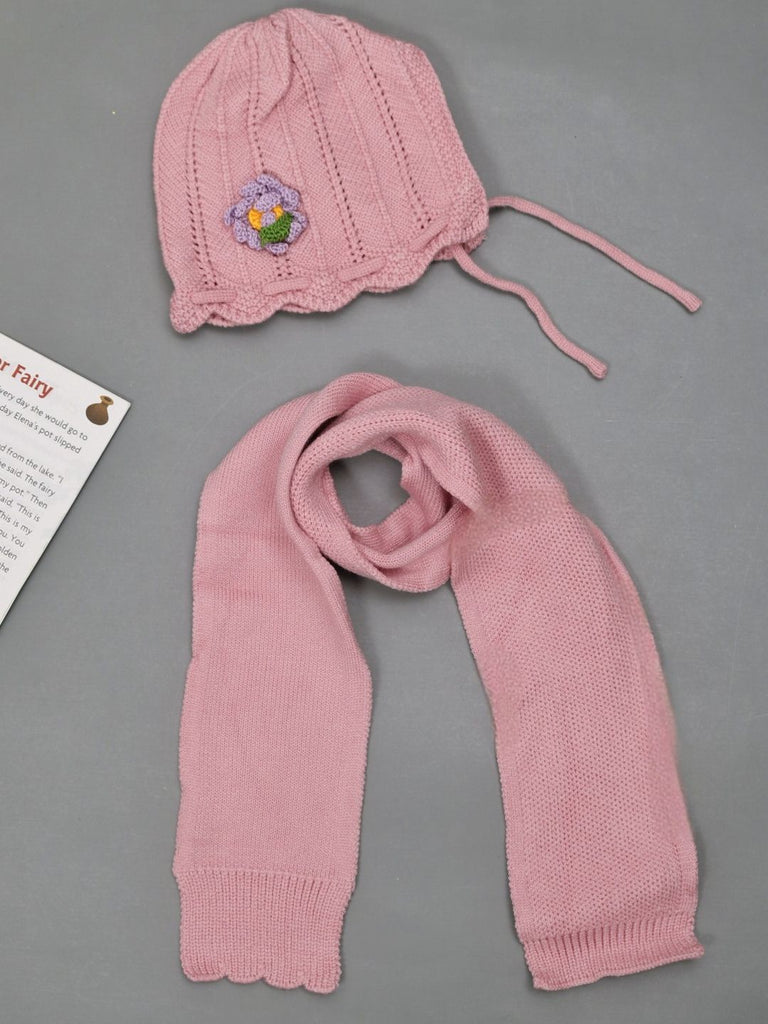 Girls' pink knit beanie with yellow flower design on display.