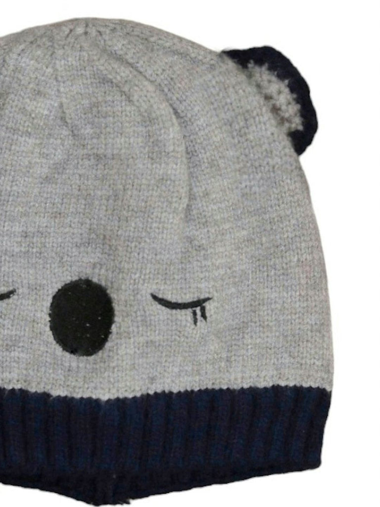 Close-up of white bear beanie's brown nose and eyes detail.