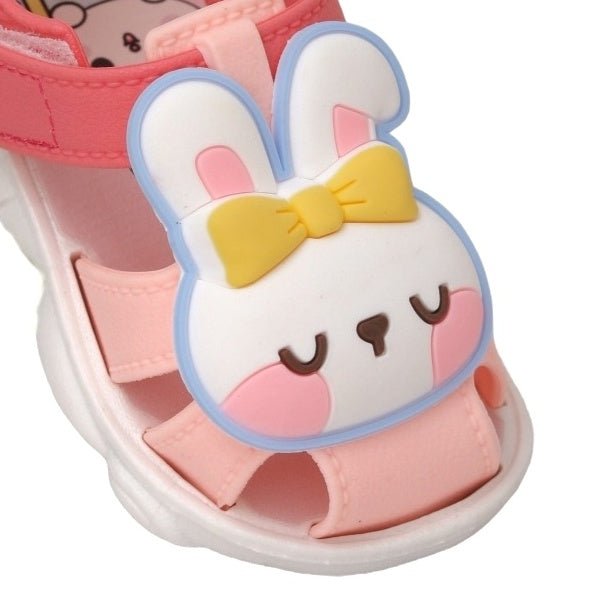 Detailed view of the cute bunny face on the front of the peach applique sandals for toddlers
