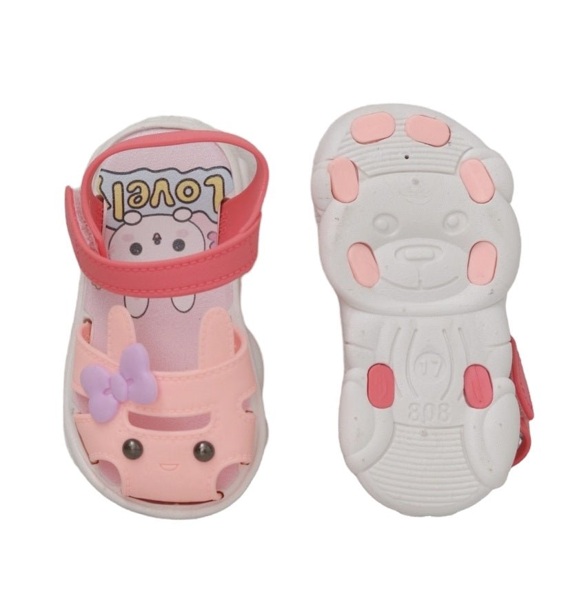 "Bottom view of peach bunny sandals displaying the non-slip sole pattern for safe toddler adventures