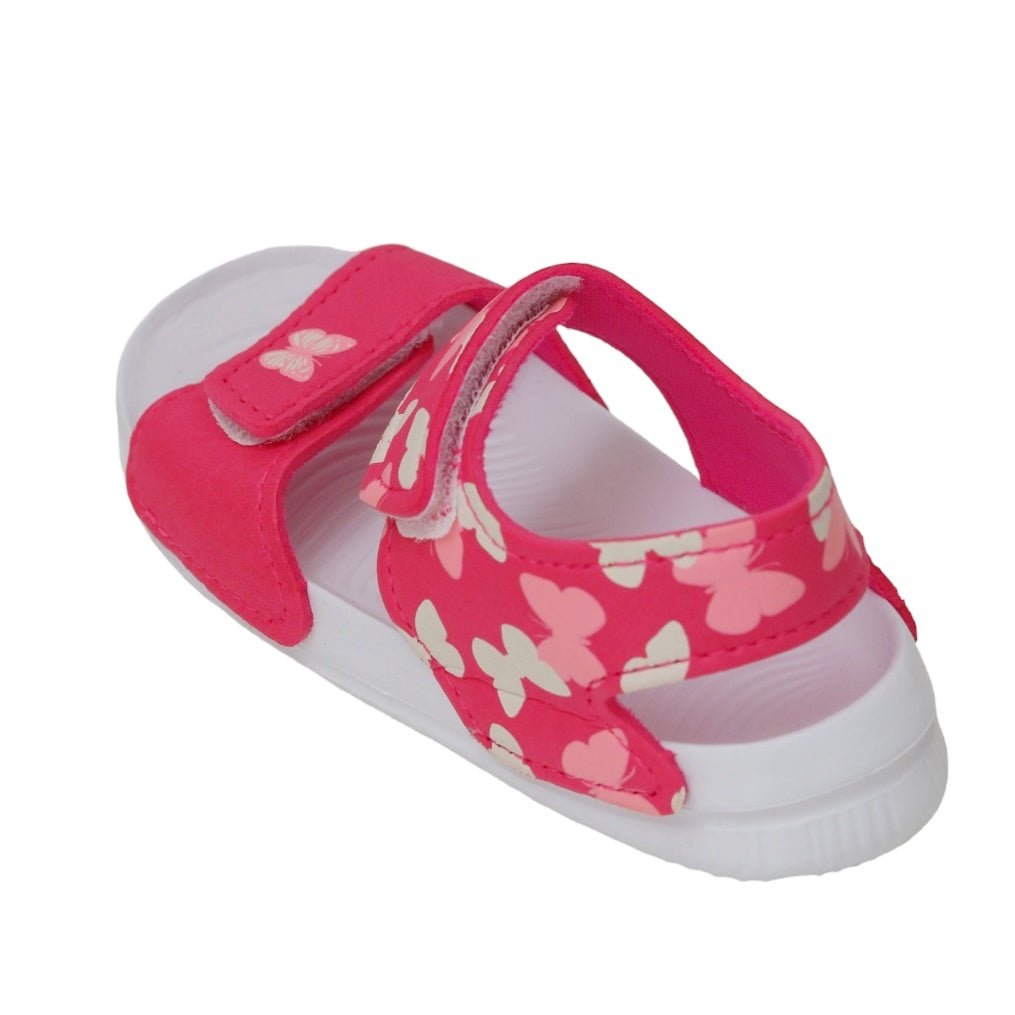 Top angle of toddler's pink sandals adorned with a butterfly print and secure strap.