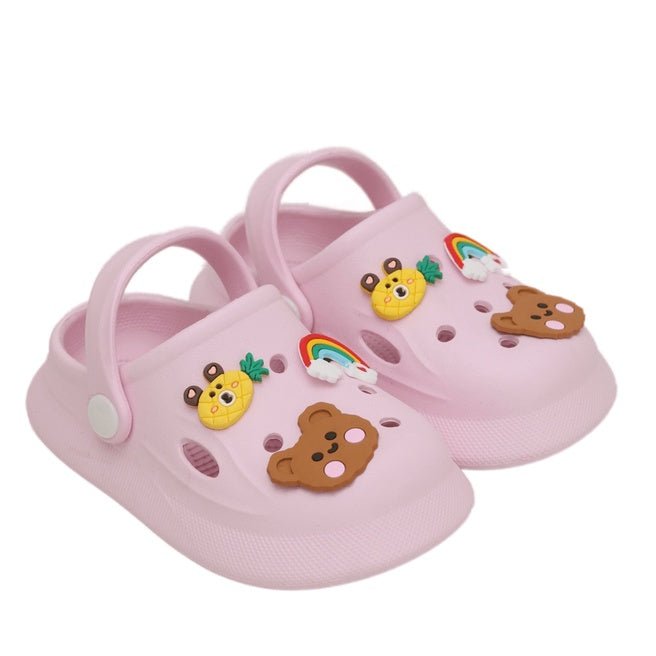 Pair of light pink clogs with colorful animal motifs on a blue background