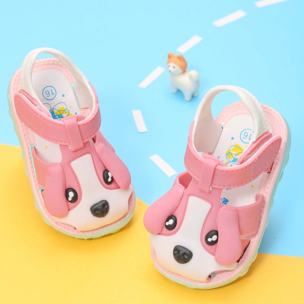  Cute pink toddler sandals with puppy face and applique design, side view on a playful background