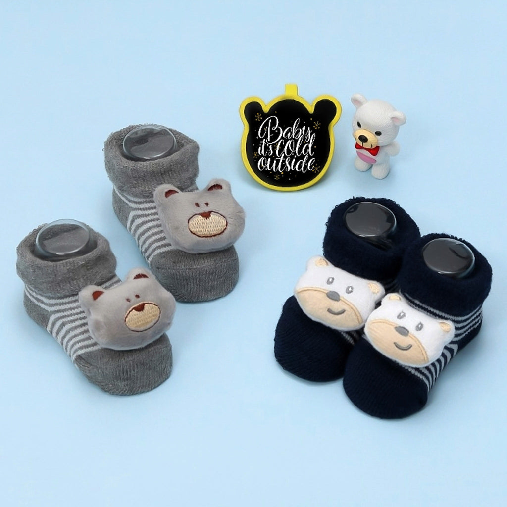 Two pairs of teddy bear stuffed toy socks with one pair in grey and the other in navy