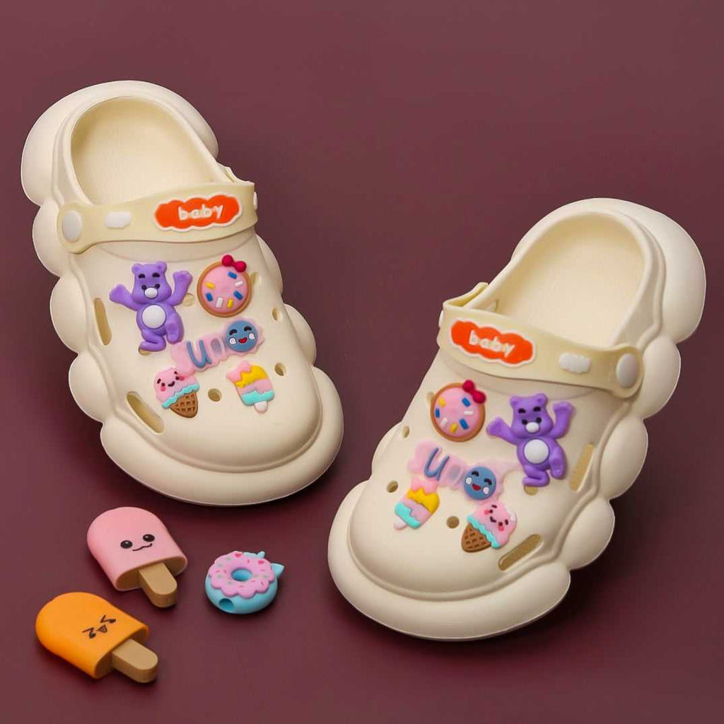 Toddler's Fantasy Clogs with colorful bear and sweet treats charms on a beige background