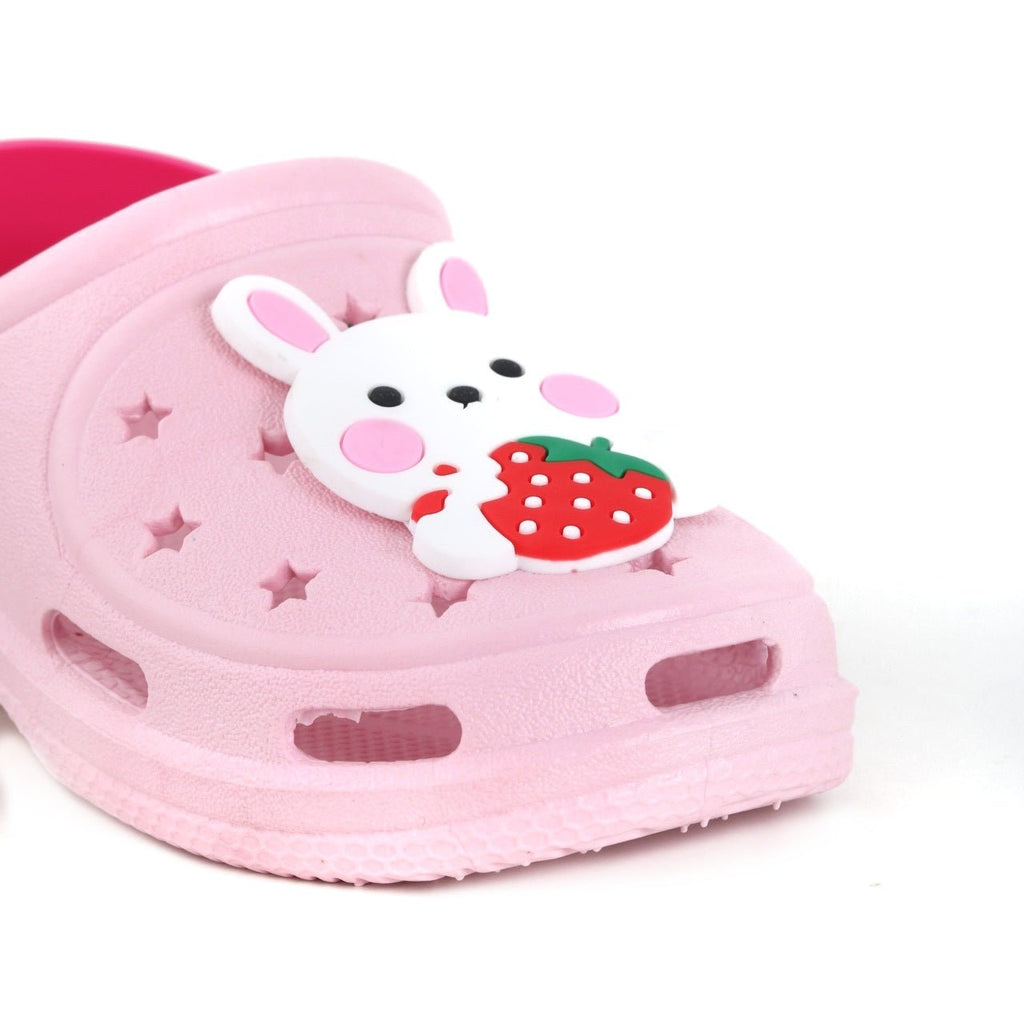 Close-up of the bunny motif on the toe of a pink child's clog with strawberry accent.