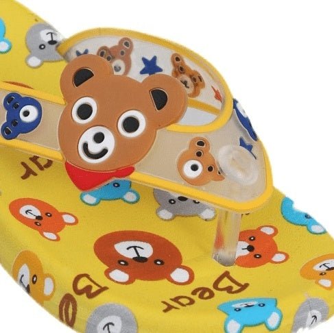 Close-up of the cheerful bear face on the strap of the kids' yellow flip flops