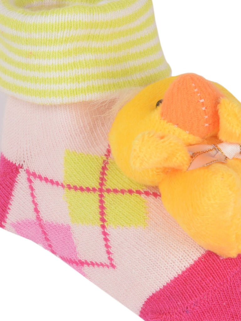 Detailed view of a stuffed doll face on cozy toddler socks