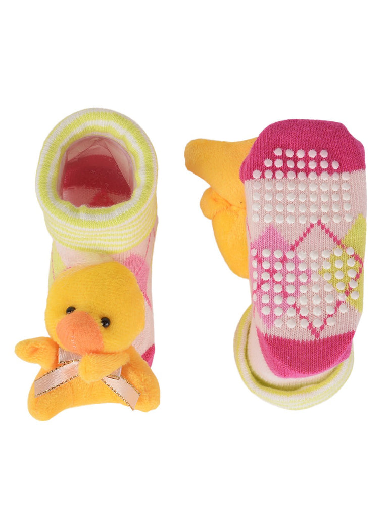 Soft pink polka-dotted socks with a playful doll toy on the toe for toddlers