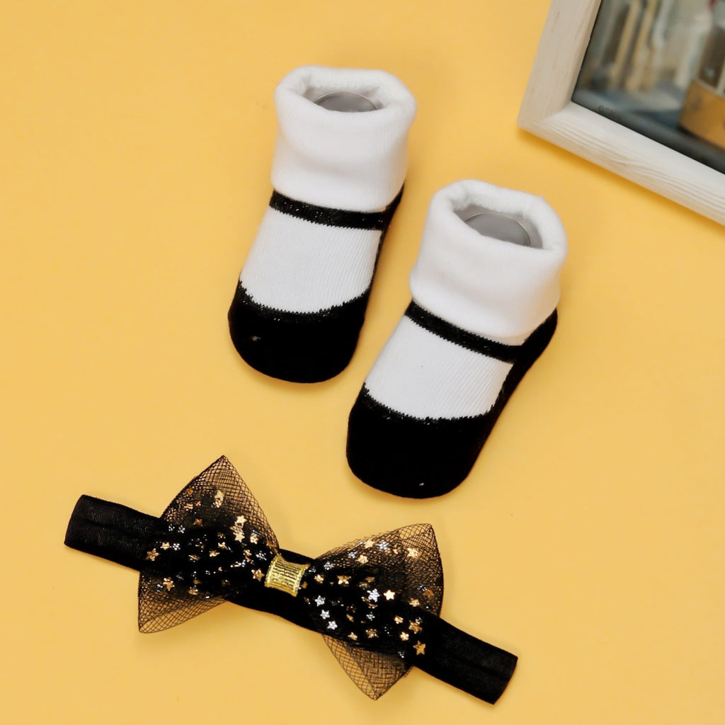 Chic black and white socks with matching bow headband on a yellow background.