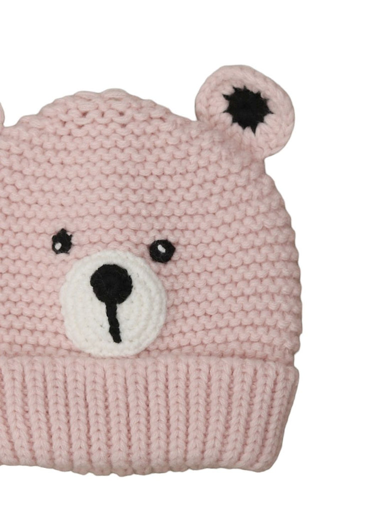 Close-up of a baby girl's pink crochet beanie with teddy bear design, emphasizing the quality craftsmanship