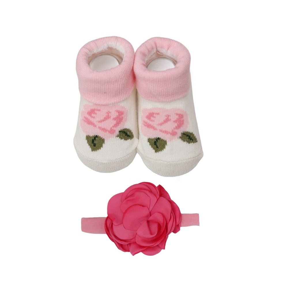 A matching set of baby girl's pink socks with floral design and a decorative pink flower headband by Yellow Bee.