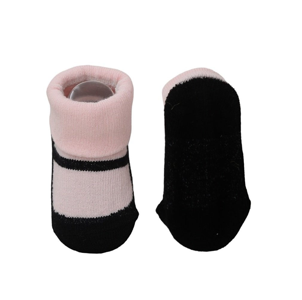 Bottom view of black and pink baby socks showcasing the anti-slip details.