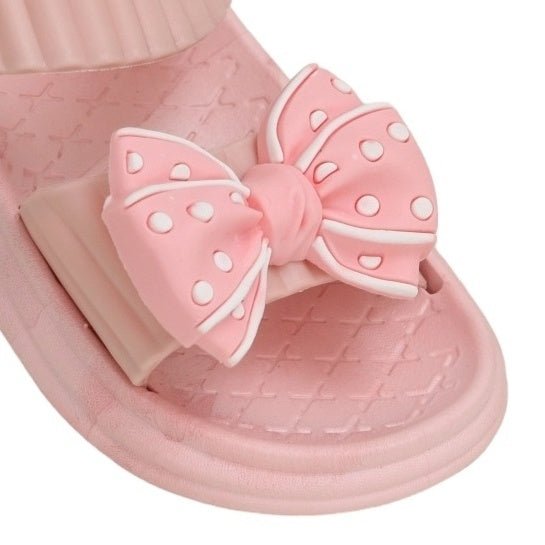 Close-up of the pink bow detail on the sandal, illustrating the intricate polka dots and playful design
