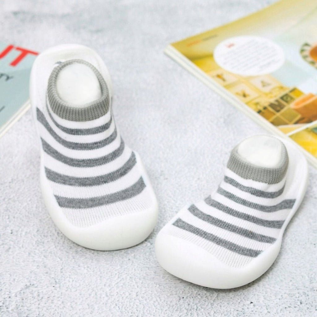 Yellow Bee black and white striped sock shoes for toddlers on cozy background