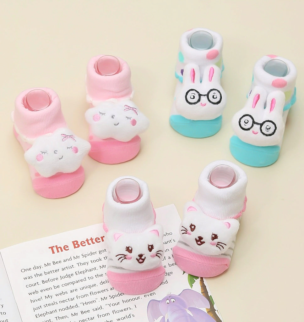Kids' stuffed toy socks set in pink and white featuring cloud, cat, and bunny designs.