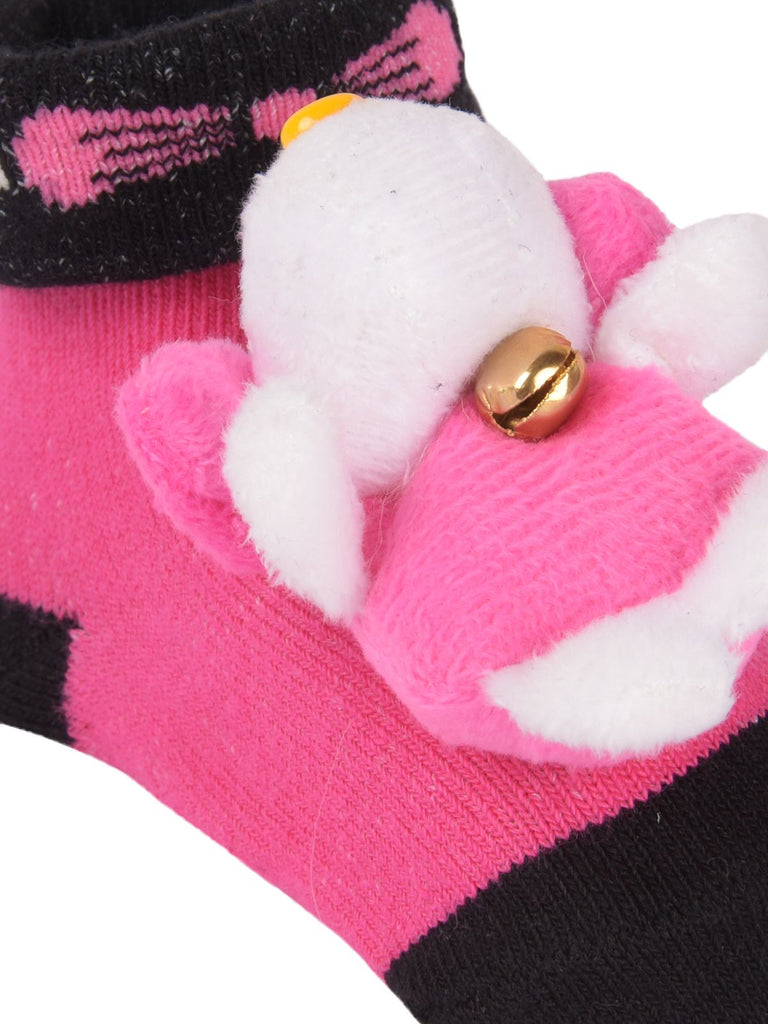 Close-up of teddy bear plush on stuffed toy socks.