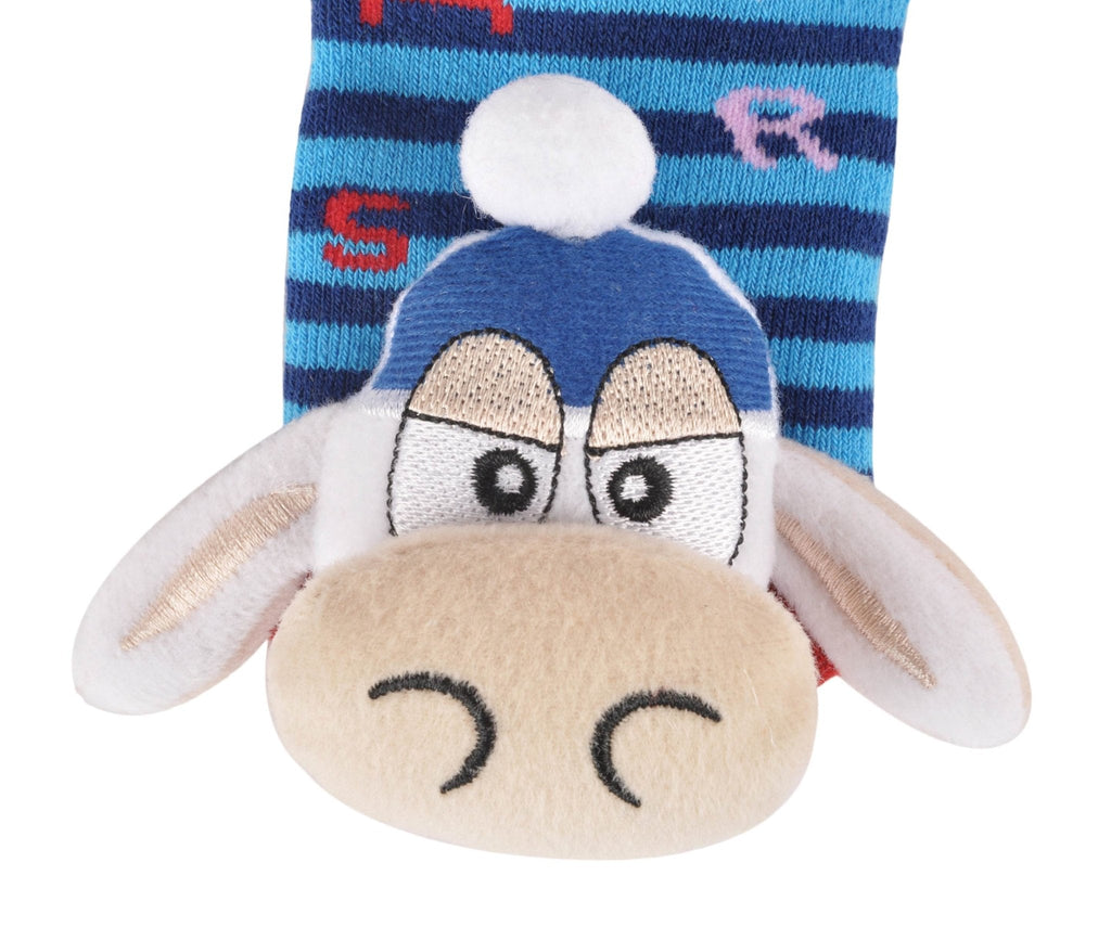 Close-up of the cow stuffed toy detail on children's blue striped socks.