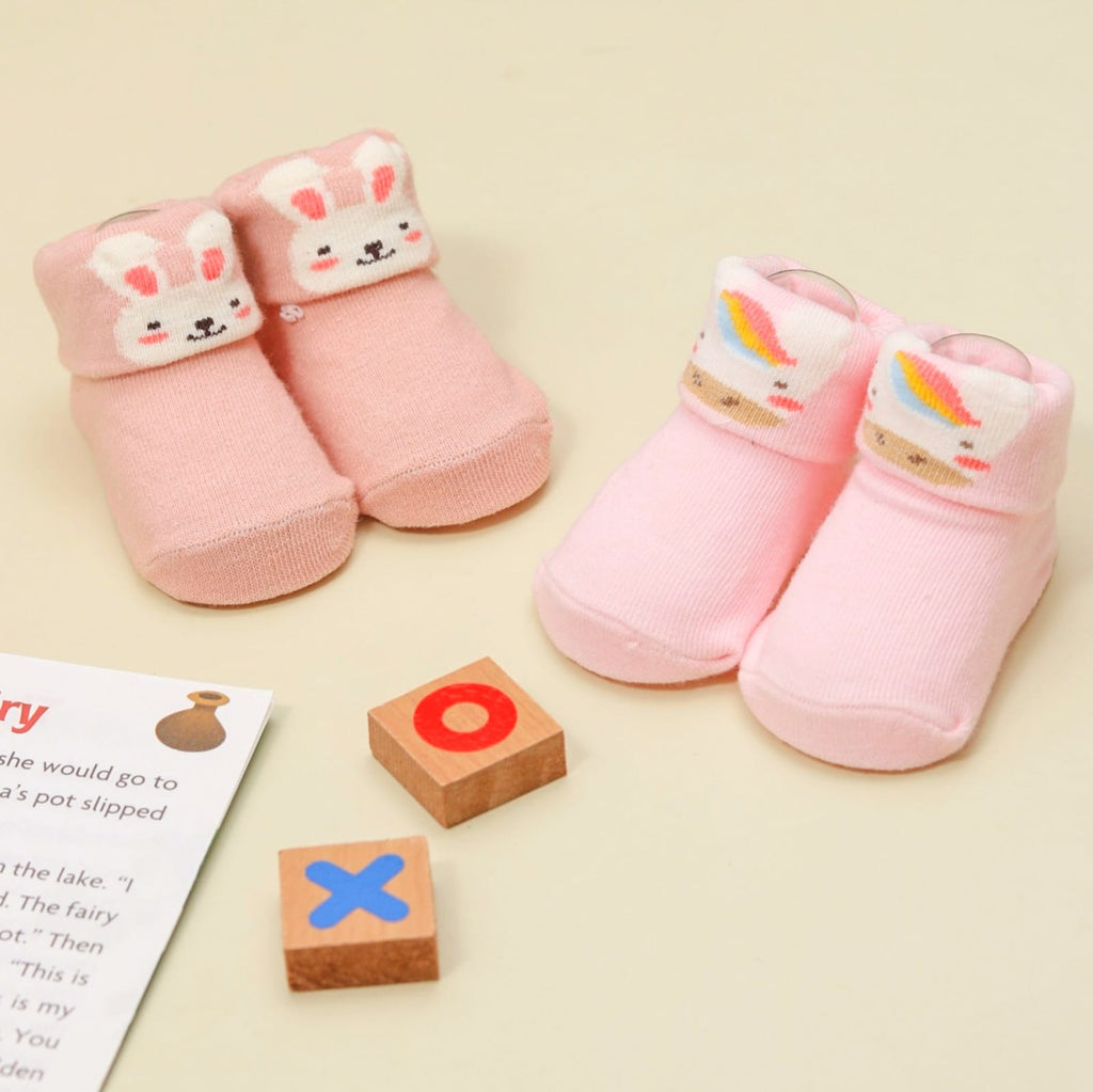 Baby girl pink unicorn and bunny socks set on display