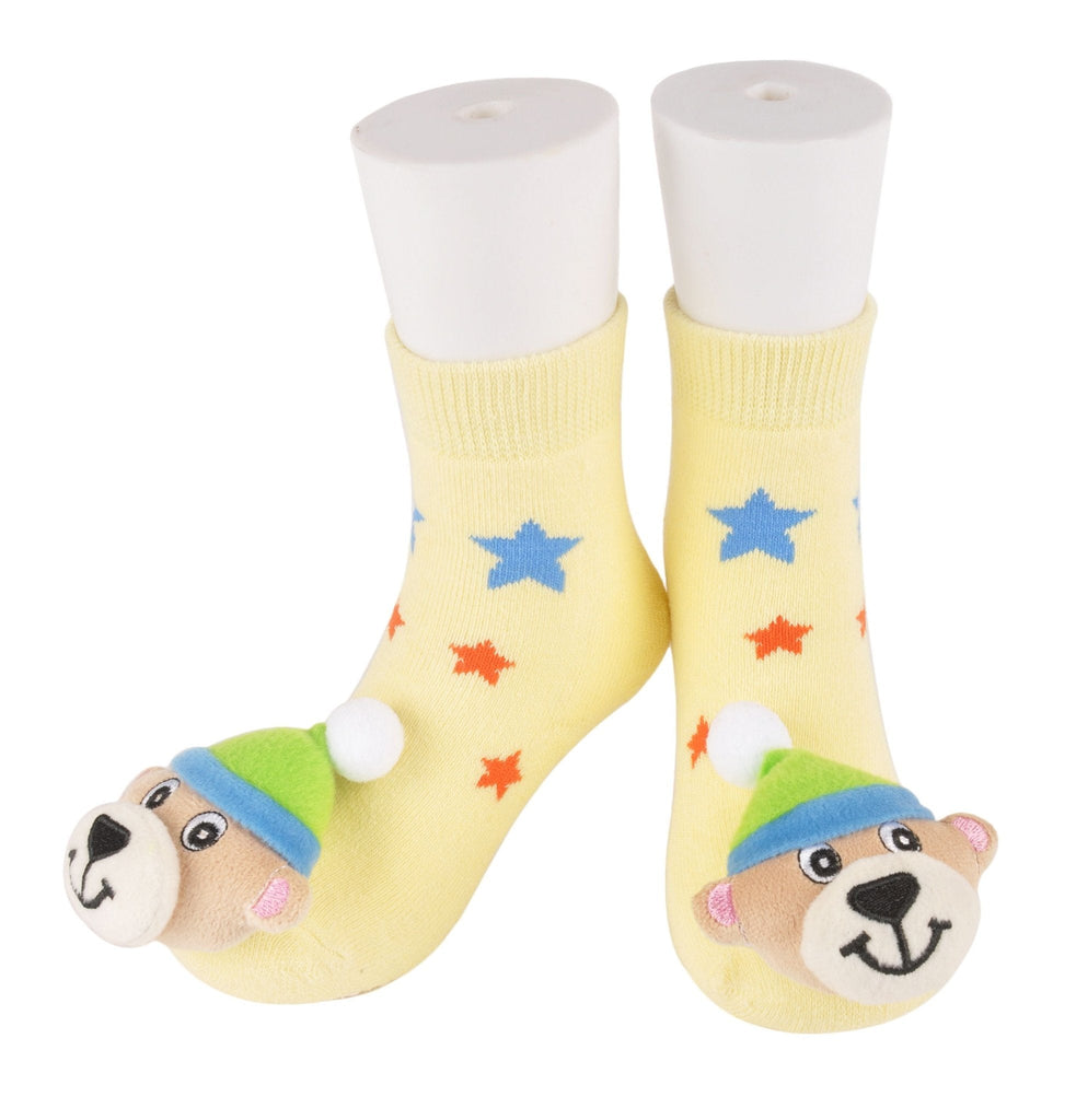 Cuddly bear face stuffed toy on yellow star-patterned kids' socks