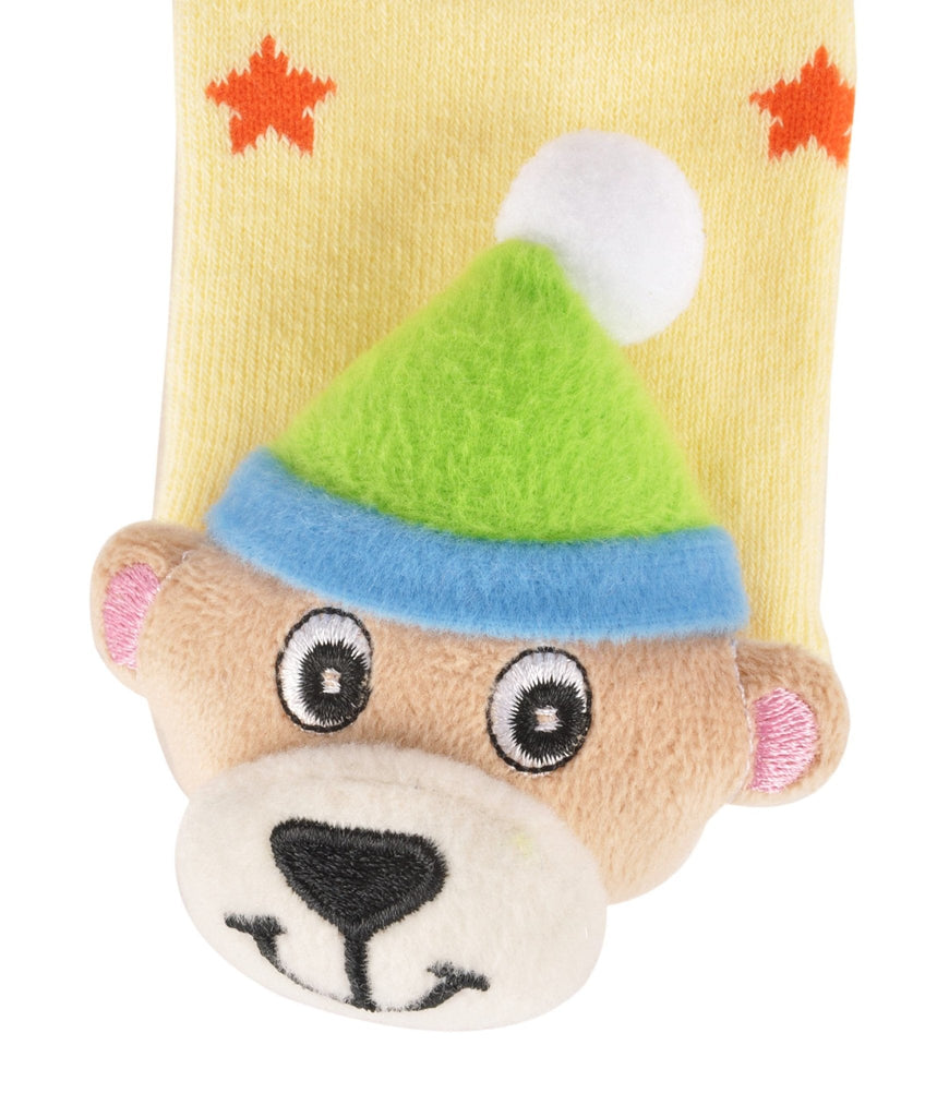 Close-up of a smiling bear stuffed toy on top of comfy kids' socks