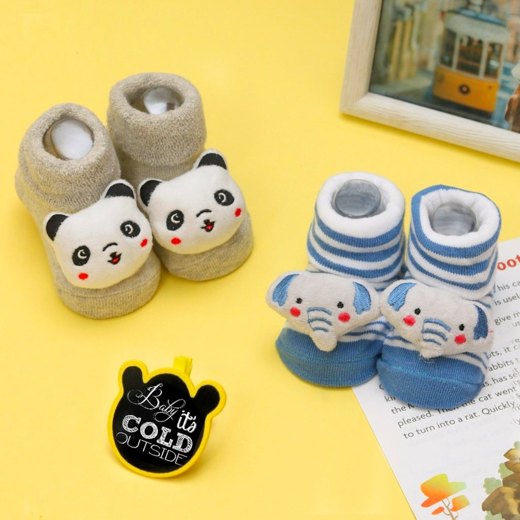 Cozy panda face baby socks set against a cheerful yellow background.