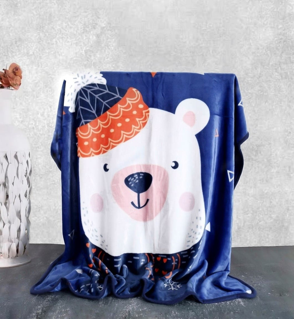 Blue polar bear kids' blanket draped over a chair, showcasing its playful design and cozy flannel texture