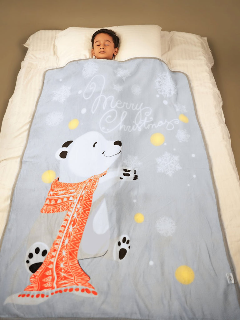 Child peacefully sleeping under a polar bear-themed blanket - Dreamland Awaits