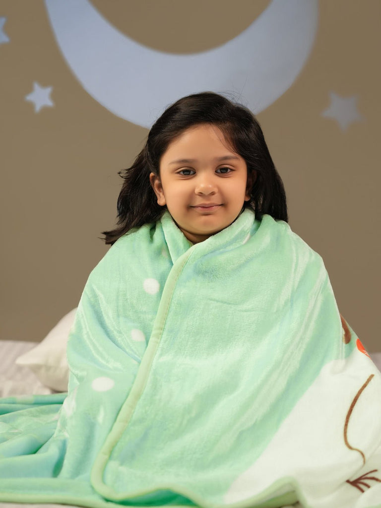 Child Smiling while Sitting with the Plush Yellow Bee Snowman Blanket