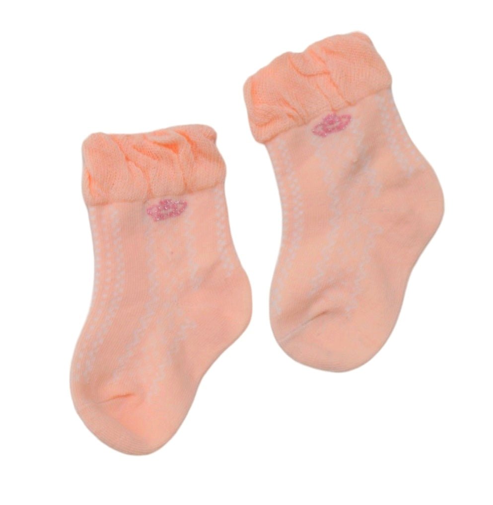 Pair of Yellow Bee's peach Crown Ruffle Cuff Socks for girls, highlighting the ruffle detail and snug fit.