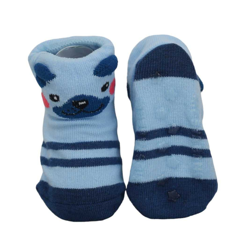 Anti-skid sole on blue striped baby socks with cute bear face for safety.