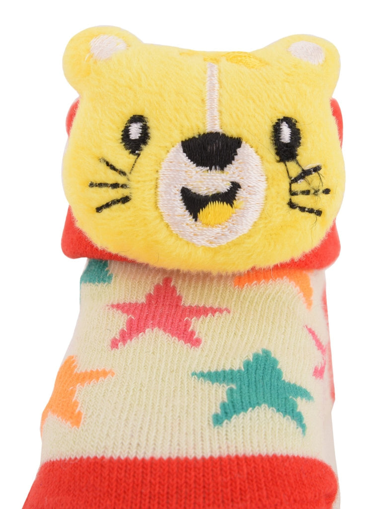 Close-up of yellow bear face on stuffed toy socks